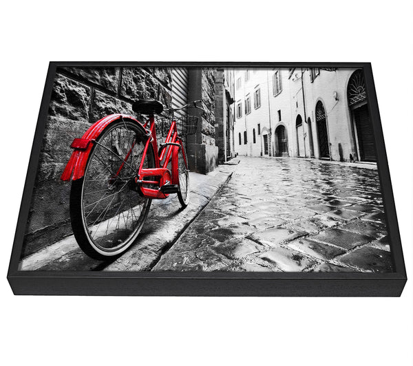 A picture of a Red Bicycle In The Cobbled Streets framed canvas print sold by Wallart-Direct.co.uk