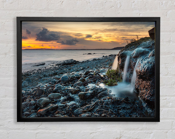 Water flows down the rocks into the sea