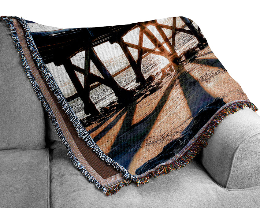 Sun Peaks Through The Pier Woven Blanket