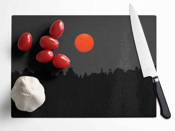 The Red Sun Over The Grey Treeline Glass Chopping Board