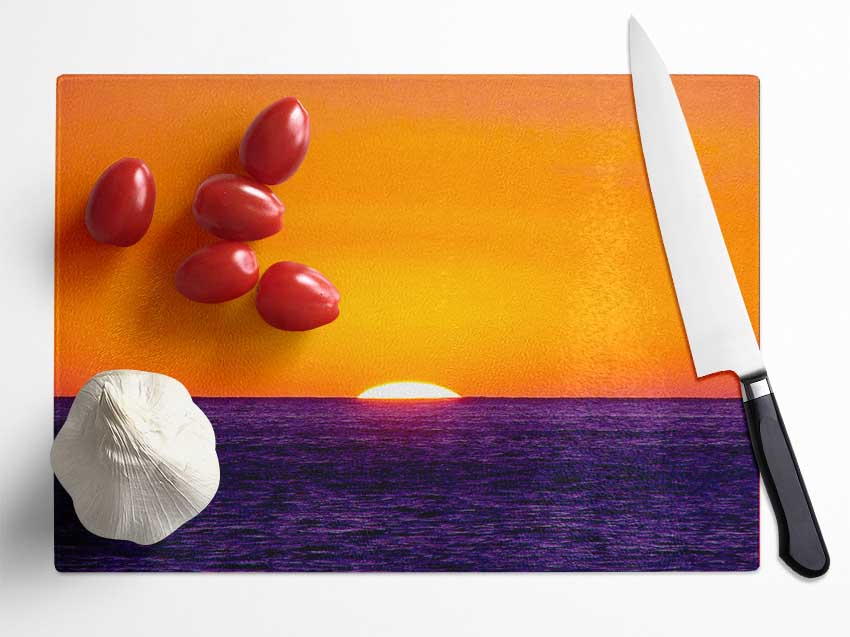 As The Sun Goes Down Over The Ocean Orange Glass Chopping Board