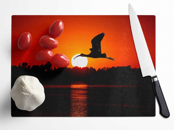 Bird Flying At Sunset Glass Chopping Board