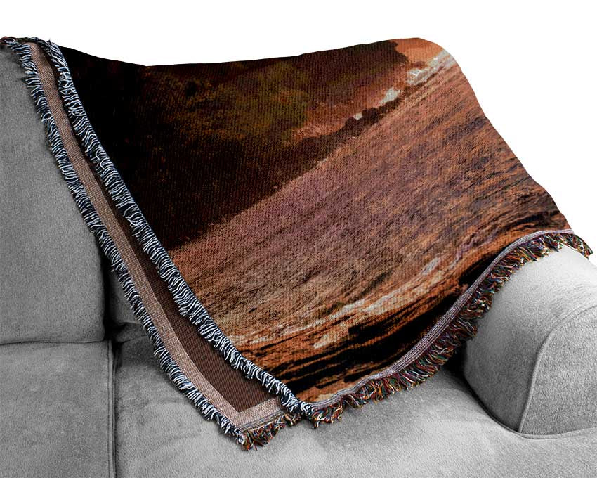 Cliff sunset crashing ocean Woven Blanket