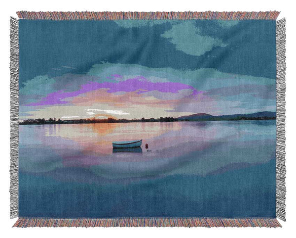 Small row boat on calm lake Woven Blanket