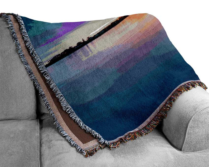 Small row boat on calm lake Woven Blanket