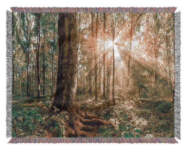 Bright light flare in the forest Woven Blanket