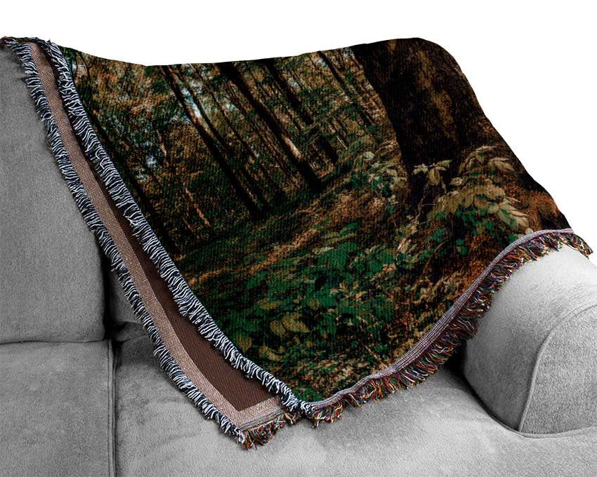 Bright light flare in the forest Woven Blanket