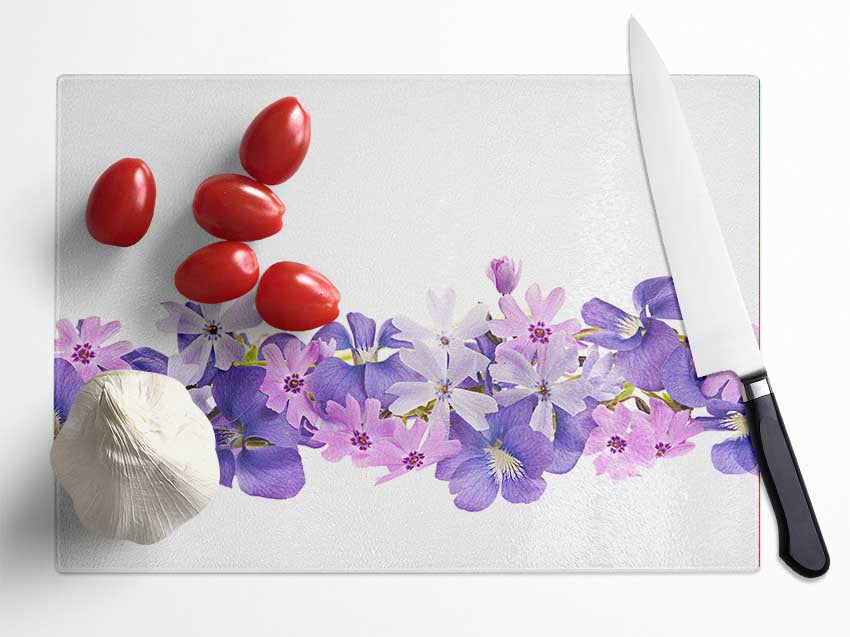 Pink and violet flowers laid out Glass Chopping Board