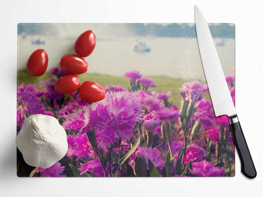 Pink flowers in the countryside Glass Chopping Board