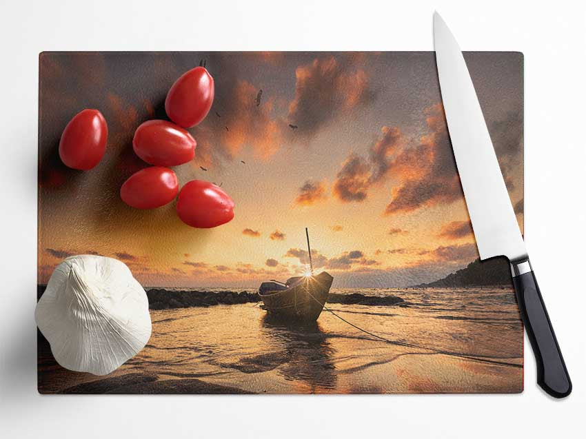 Sunset finishing boat on the beach Glass Chopping Board