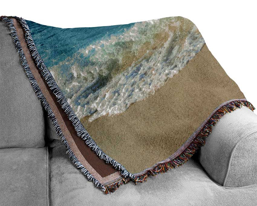 Crashing waves on the sandy beach Woven Blanket