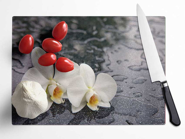 Orchid heads in water Glass Chopping Board