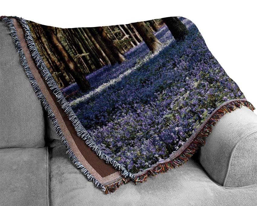 Beautiful purple flowers in the woods Woven Blanket