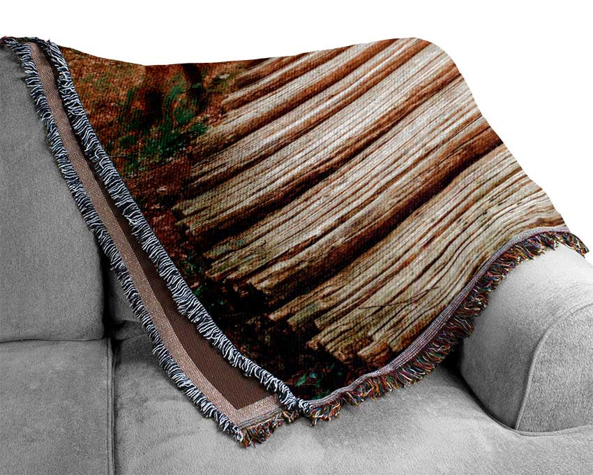 Log trail through the woods Woven Blanket