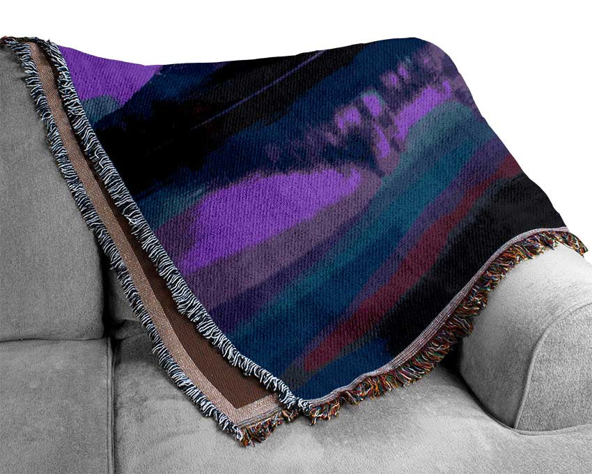 Purple and blue mountains above lake Woven Blanket