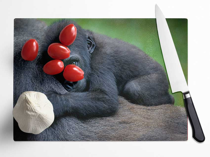 Baby gorilla Holding on Glass Chopping Board