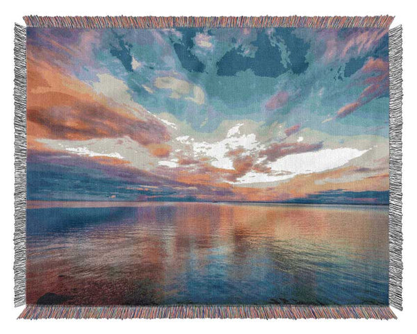 Stunning skies above the sea Woven Blanket