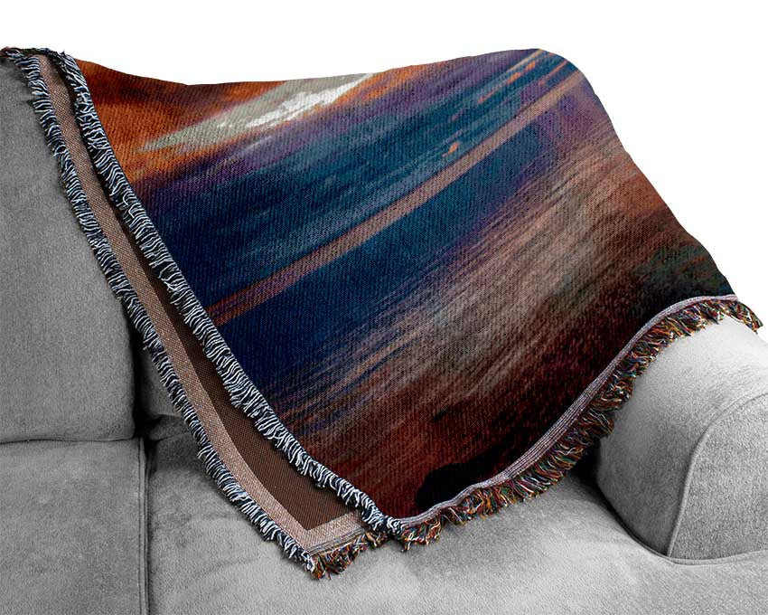 Stunning skies above the sea Woven Blanket