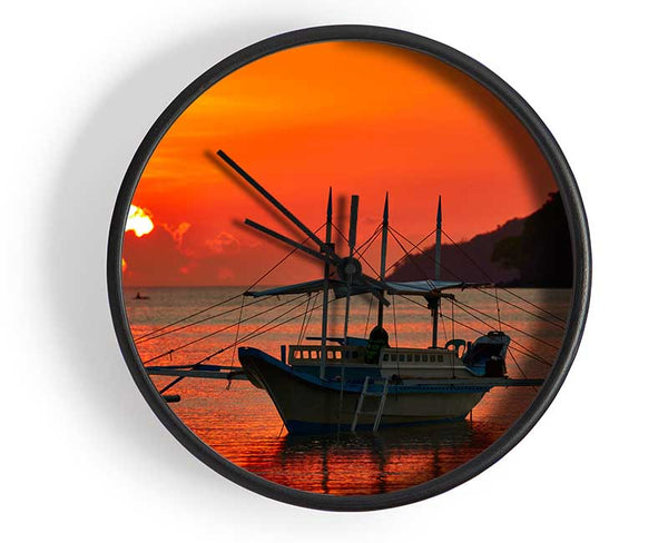 Boat sailing in the orange sunset Clock - Wallart-Direct UK