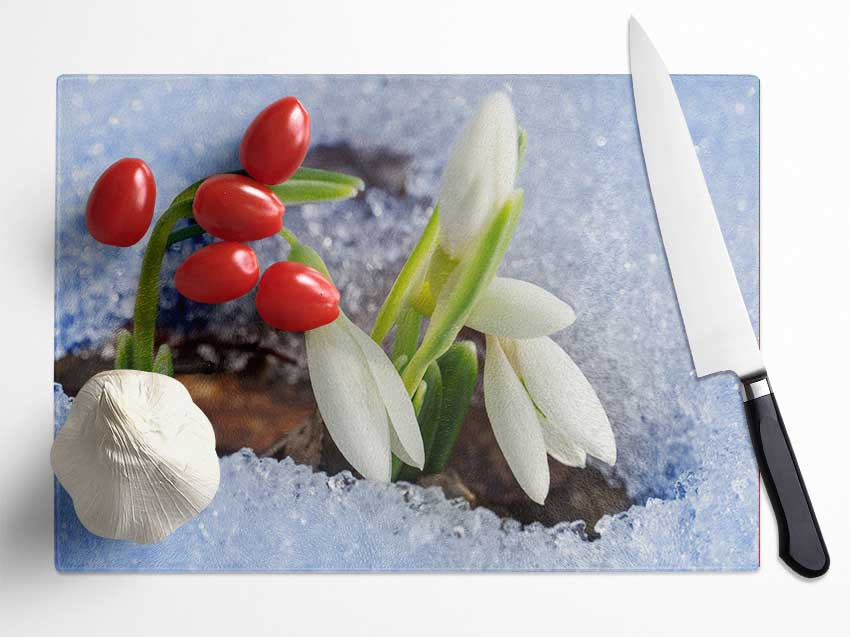 White snowdrops peering through the snow Glass Chopping Board