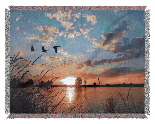 Swans flying over the lake Woven Blanket