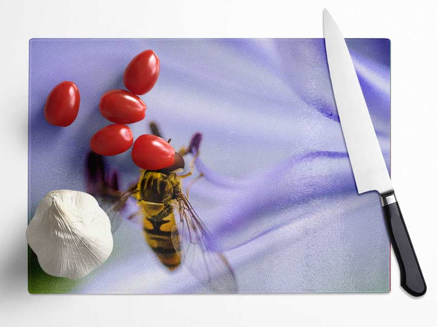 Hover fly on a purple flower Glass Chopping Board