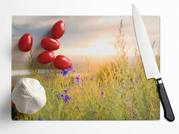 Purple flower suspended in the sunlight Glass Chopping Board