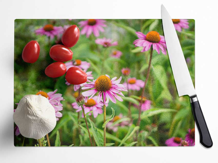 Pink flowers down below in the grass Glass Chopping Board