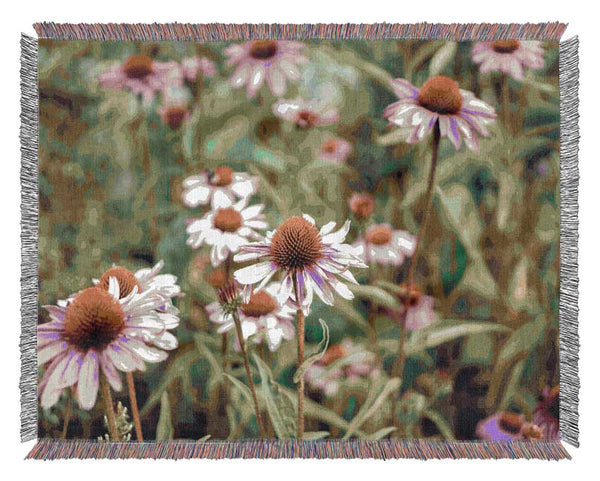 Pink flowers down below in the grass Woven Blanket