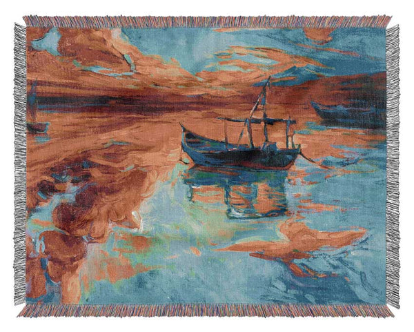 Row boat on the horizon of colour Woven Blanket