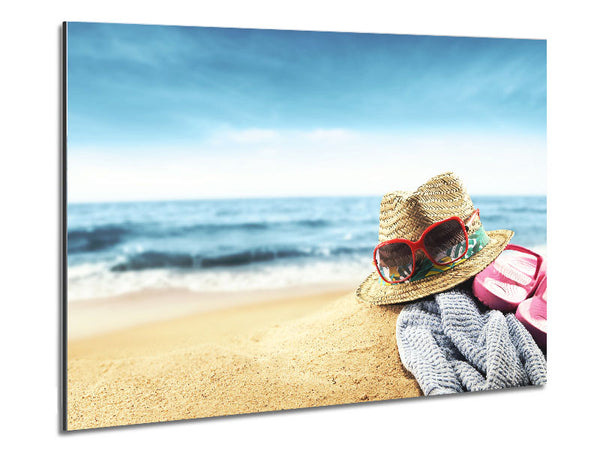 Sun hat and sunglasses on the beach