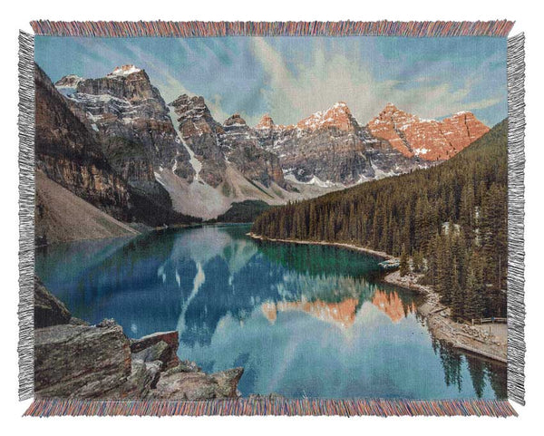 Crystal clear lake in the mountain range Woven Blanket